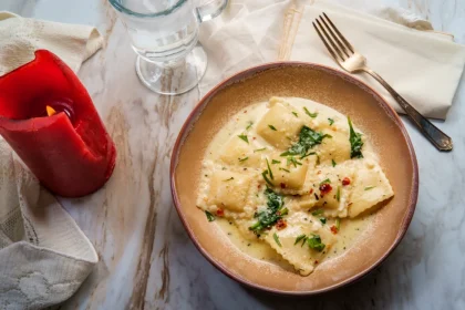 cheese-ravioli-tuscan-creamy-sauce-spinach Handmade pasta Singapore – ravioli in creamy sauce with spinach and cheese.
