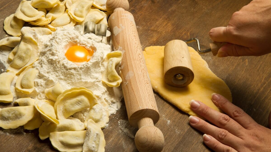 Preparing handmade ravioli in Singapore with egg, flour, and pasta tools