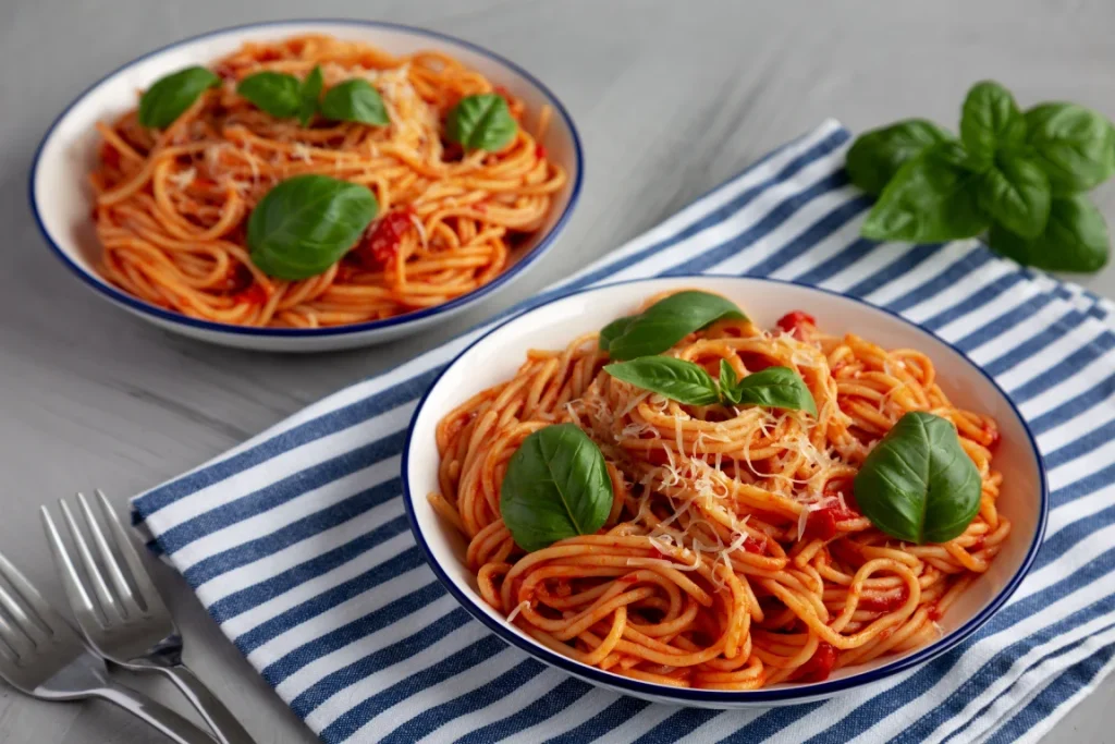  a plate of Pasta al Pomodoro (Fresh San Marzano Tomatoes & Basil)